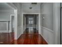 Hallway featuring pristine hardwood floors, neutral paint, and classic trim throughout at 703 Cokey Rd, Rocky Mount, NC 27801