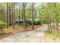 Long driveway leading to a charming home with beautiful trees at 706 Kensington Dr, Chapel Hill, NC 27514
