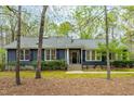 Lovely single-story home featuring gray siding, a well-maintained lawn, and mature trees at 706 Kensington Dr, Chapel Hill, NC 27514