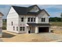 Two-story home featuring an attached two-car garage and unfinished yard at 709 Compeer Way # 32, Rolesville, NC 27571