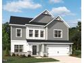 Charming two-story home with gray siding, white trim, and a two-car garage at 709 Compeer Way # 32, Rolesville, NC 27571