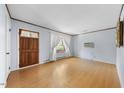 Bright living room featuring wood floors, neutral walls, and a front-facing window at 711 Melanie St, Durham, NC 27704