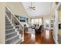 Elegant living room with hardwood floors, vaulted ceiling, and a cozy fireplace at 8308 Buck Crossing Dr, Durham, NC 27713