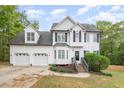 Charming two-story home featuring a manicured lawn, a bay window, and a two-car garage at 9332 Carley Cir, Garner, NC 27529