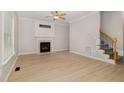 Bright living room boasts fresh paint, hardwood floors, a fireplace, and staircase at 9332 Carley Cir, Garner, NC 27529