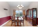 Classic dining room with a large china cabinet, ample light and hardwood floors at 1008 Double Spring Ct, Apex, NC 27502