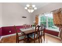 Traditional dining room with hardwood floors, large window and decorative chandelier at 1008 Double Spring Ct, Apex, NC 27502