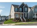 Stylish two-story home showcasing a welcoming front porch and attractive exterior at 109 Broadwater Dr, Wake Forest, NC 27587