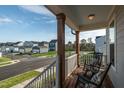 Relaxing front porch view with rocking chairs, offering a serene outdoor living space and neighborhood view at 109 Broadwater Dr, Wake Forest, NC 27587