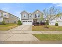 Well-kept two-story home with a two-car garage, verdant grass, and neatly trimmed bushes creating curb appeal at 109 Oak Rise Ln, Fuquay Varina, NC 27526