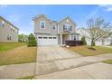 A home with a two-car garage and green lawn, the home has a well-maintained yard and landscaping at 109 Oak Rise Ln, Fuquay Varina, NC 27526