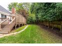 View of a well-maintained lawn and wooden deck at 109 Yorkchester Way, Raleigh, NC 27615