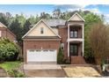 Two story brick home with a two car garage and balcony at 1104 Hobson Ct, Raleigh, NC 27607