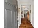 Welcoming entryway with hardwood floors, decorative lighting, and views of the living spaces at 1108 Cadence Ln, Durham, NC 27703