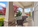 Inviting front porch with rocking chairs, stone accents, and a view of the landscaped yard at 1108 Cadence Ln, Durham, NC 27703
