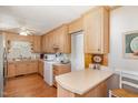 Cozy kitchen with light wood cabinets, breakfast bar, and hardwood floors at 1108 Friendly Rd, Dunn, NC 28334