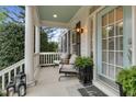Relaxing front porch with seating, potted plants, and a welcoming mat; an outdoor living space at 1113 Colonial Club Road Rd, Wake Forest, NC 27587