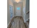 Inviting foyer with hardwood floors and views into the home's office and staircase at 112 Surles Landing Way, Benson, NC 27504