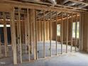 Unfinished living room showing the stud framing, electrical boxes, and rough-in plumbing at 112 Surles Landing Way, Benson, NC 27504