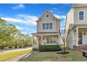 Charming two-story home with a cozy front porch and manicured lawn at 115 Windy Creek Ln, Apex, NC 27502