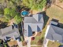 Expansive aerial view of the property showcasing its well-maintained landscape, private pool, and serene surroundings at 116 Palermo Ct, Apex, NC 27539