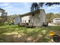 View of the house from the large backyard with a deck at 1431 Cherrycrest Dr, Durham, NC 27704