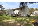 Home featuring a spacious backyard with a wooden deck, perfect for outdoor gatherings at 1431 Cherrycrest Dr, Durham, NC 27704