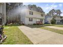 A two-story home with tidy landscaping and a private drive on a sunny day at 1431 Cherrycrest Dr, Durham, NC 27704