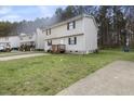 Two-story home with a wide lawn and mature trees offers a suburban retreat at 1431 Cherrycrest Dr, Durham, NC 27704