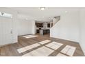 Bright living space with wood-look floors leading into a modern kitchen area at 1431 Goldsboro Ave, Sanford, NC 27330