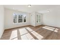 Sunlit living room features wood-look floors and ample windows for natural light at 1431 Goldsboro Ave, Sanford, NC 27330