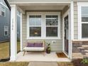 Inviting front porch featuring a cozy bench with decorative pillows and a charming welcome mat at 1726 Wimberly Rd, Apex, NC 27523