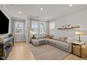 Bright and airy living room with a large sectional couch and natural light at 1726 Wimberly Rd, Apex, NC 27523
