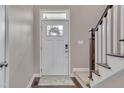 Bright entryway showcasing a door with glass inserts and adjacent stairway at 190 Alcock Ln, Youngsville, NC 27596