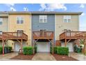 Townhome exterior showcases multiple decks, garages and freshly maintained landscaping at 228 Dove Cottage Ln, Cary, NC 27519