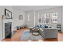 Bright living room features wood floors, stylish decor, lots of natural light and cozy seating at 228 Dove Cottage Ln, Cary, NC 27519