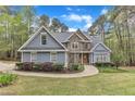 Inviting two-story home with blue siding, stone accents, a manicured lawn and a winding walkway at 250 Highview Dr, Youngsville, NC 27596