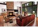 Bright living room showcasing a stone fireplace, high ceilings, recessed lighting, and views of the outdoor landscape at 2637 Buckeye Ct, Wake Forest, NC 27587