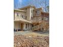 Expansive rear view of a multi-level home with a screened-in porch and wooden decks at 2811 Chicken Bridge Rd, Pittsboro, NC 27312