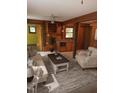 Cozy living room features wood walls and ceilings, with a small sink and shelving at 2811 Chicken Bridge Rd, Pittsboro, NC 27312