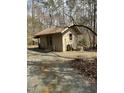 Quaint wooden shed with a metal roof and double doors surrounded by trees at 2811 Chicken Bridge Rd, Pittsboro, NC 27312