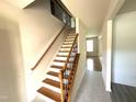 Elegant staircase with wood and iron railing, leading to the upper level of the home at 317 Hope Valley Rd, Knightdale, NC 27545