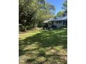 Expansive backyard offers privacy with mature trees and a patio for outdoor enjoyment at 3438 Leonard St, Raleigh, NC 27607