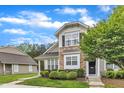 Inviting townhome showcasing manicured landscaping and a charming stone facade at 345 Red Elm Dr, Durham, NC 27713