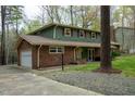 A well-maintained home with brick accents, attached garage, and landscaped front yard and long driveway at 3518 Donnigale Ave, Durham, NC 27705