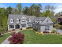 Aerial view of a gray home with manicured lawn, mature trees, and architectural details at 417 Westbury Dr, Chapel Hill, NC 27516