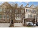 Charming brick and siding townhome with attached garage and mature landscaping at 452 Panorama Park Pl, Cary, NC 27519