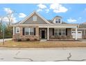 Charming single-story home with brick and gray siding, a covered porch, and well-maintained landscaping at 4712 Bright Pebble Ct, Raleigh, NC 27604
