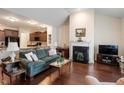 Bright living room with fireplace, hardwood floors, and a view into the dining area at 4712 Bright Pebble Ct, Raleigh, NC 27604