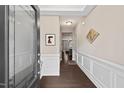 Welcoming foyer featuring beautiful wainscoting and hardwood floors at 5 Galway Glenn Ln, Durham, NC 27705